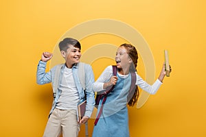 Excited interracial schoolkids with backpacks 