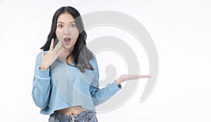 Excited joy asian woman raised up hand on empty standing on white background. Confident smile young girl showing copy space on