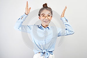 Excited kazakh asian girl clasped her hands opened mouth in surprise and bulged eyes against white background, . Portrait