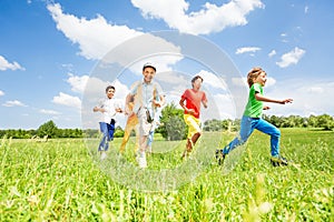 Excited kids playing and running in the field