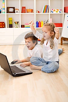 Excited kids about to win computer game