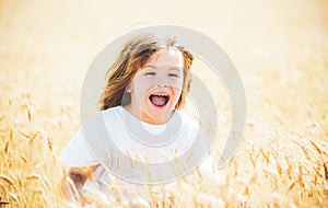 Excited kids on wheat field. Happy boy on wheat field looking up. Laughing child on wheat field. Kid smile face.