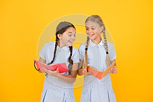Excited about knowledge. old school. happy friends in retro uniform. vintage kid fashion. back to school. small girls
