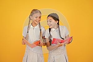 Excited about knowledge. old school. happy friends in retro uniform. vintage kid fashion. back to school. small girls