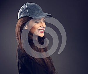 Excited laughing beautiful brunette woman in baseball blue cap w