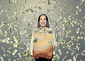 Excited laughing woman holding money