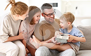 Young happy family celebrating holiday together at home