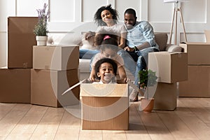 Excited little kids have fun playing on moving day