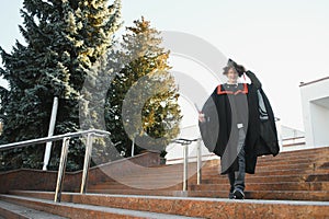 Excited male student in mantle scream graduate from university finish course studying. Happy man triumph holding college