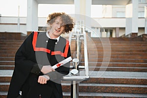 Excited male student in mantle scream graduate from university finish course studying. Happy man triumph holding college