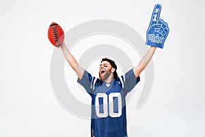 Excited man fan in blue t-shirt standing isolated