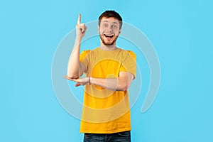 Excited man having great idea and pointing up