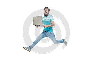 Excited man midair isolated on white. Bearded man jumping with laptop. Energetic man computing