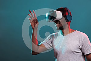 Excited man playing virtual game on interactive vr headset