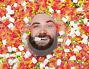 Excited man posing in candies