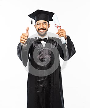 Excited man wearing toga with thumbs up holding diploma paper