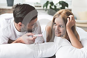 Excited married couple discovering result of pregnancy test