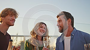 Excited mates enjoy party on sunny roof close up. Happy people dancing sunlight