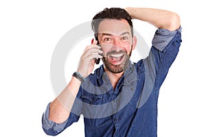 Excited mature man using on cellphone and laughing