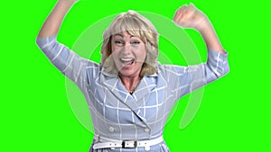 Excited mature woman on green screen.