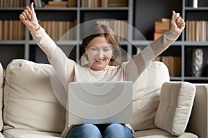 Excited mature woman looking at laptop screen, reading good news