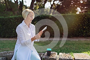 Excited mature woman reading a book