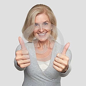 Excited mature woman showing thumbs up