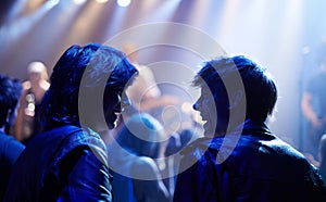 Excited men, friends and fans at music festival, lights and crowd in silhouette at live band performance on stage