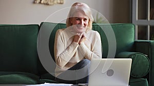 Excited middle aged woman feel winner looking at laptop