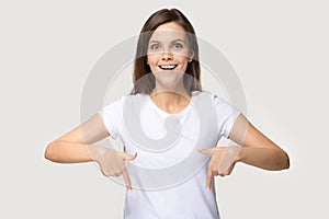 Excited millennial woman headshot showing down with her fingers