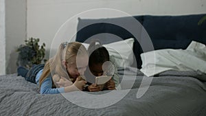 Excited multi ethnic kids watching video on phone