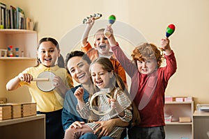 excited multiethnic kids playing musical instruments