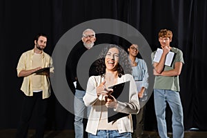 excited multiracial actress laughing and pointing