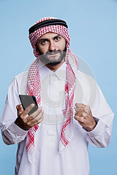 Excited muslim man showing yes gesture