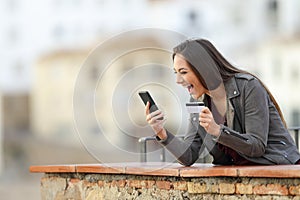 Excited online buyer finding offer on phone
