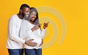 Excited pregnant woman showing her husband amazing sale