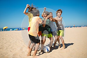 Excited preteen boy friends rejoicing after game