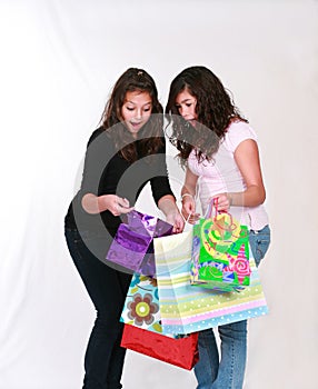 Excited preteens with shopping bags