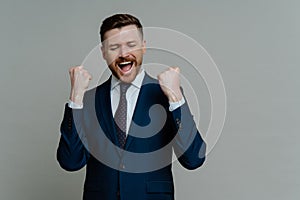 Excited professional businessman screaming and celebrating triumph