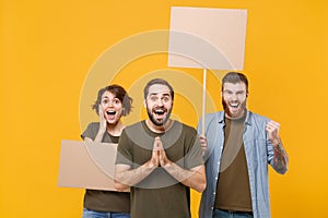 Excited protesting young people guys girl hold protest signs broadsheet blank placard on stick keeping mouth open