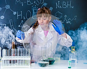 Excited schoolgirl in fume after chemical experiment