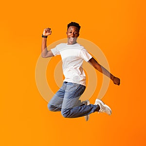 Excited screaming african man jumping while celebrating