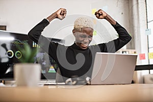 Excited screaming young african business man or entrepreneur working with laptop computer