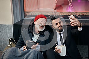 Excited senior homeless with businessman