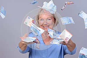 Excited senior lady celebrating a windfall photo