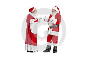 Excited senior man and beautiful woman, Santa Claus and missis Claus in traditional New Year costume isolated on white