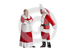 Excited senior man and beautiful woman, Santa Claus and missis Claus in traditional New Year costume isolated on white