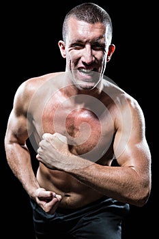 Excited shirtless man flexing muscles