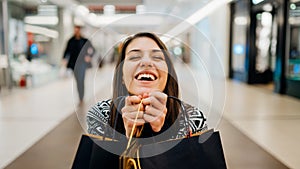 Excited shoppingholic woman in shopping mall.Buying in designer store.Wardrobe sale shopping.Hoby buyer.Weakness for clothes.