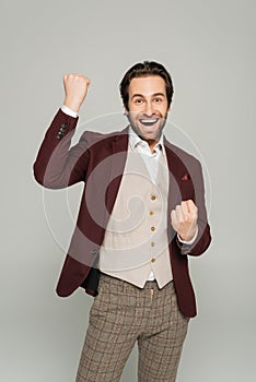 excited showman in red blazer gesturing